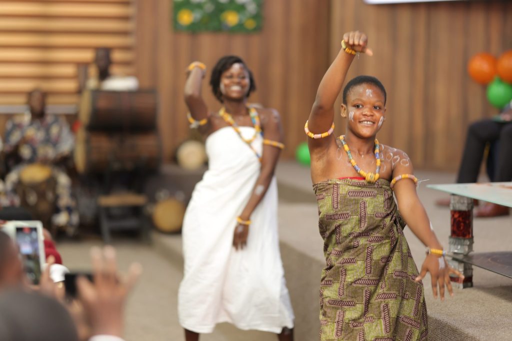 Two young women in traditional dress performing a dance at the SIIMT Graduation 2025