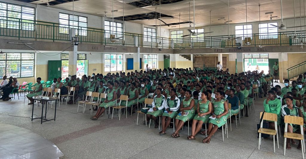 Students in green uniforms seated in the school hall at the SIIMT orientation at Nungua SHS